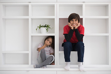 Image showing young boys posing on a shelf