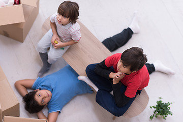 Image showing boys with cardboard boxes around them top view