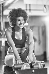 Image showing black woman doing sit ups at the gym