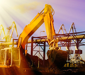 Image showing Hydraulic excavator at work. Shovel bucket against blue sky