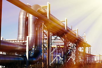 Image showing industrial pipelines on pipe-bridge against blue sky