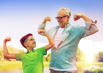 Image showing happy grandfather and grandson showing muscles