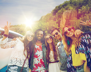 Image showing hippie friends at minivan car showing peace sign