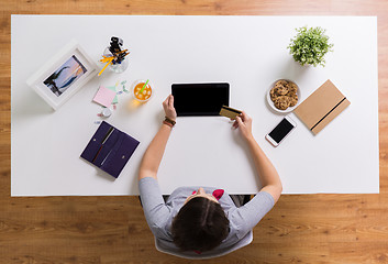 Image showing woman with tablet pc and credit card at table