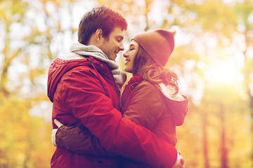 Image showing happy young couple hugging in autumn park