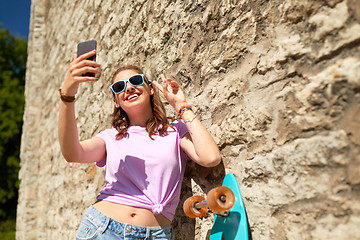 Image showing happy teenage girl with longboard and smartphone