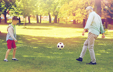 Image showing old man and boy playing football at summer park