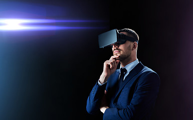 Image showing businessman in virtual reality headset over black