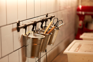 Image showing bakery kitchen tools hanging on wall in buckets