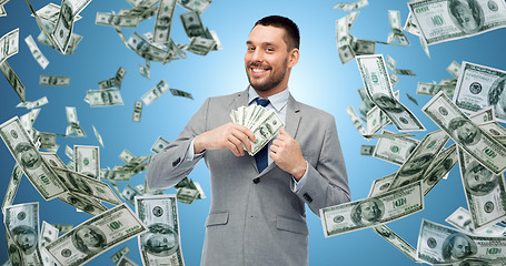 Image showing smiling businessman with american dollar money