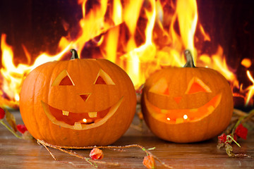 Image showing carved halloween pumpkins on table over fire