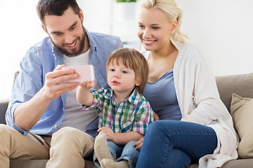 Image showing happy family with smartphone at home