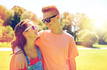 Image showing happy teenage couple looking at each other in park