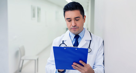 Image showing doctor writing to clipboard at hospital