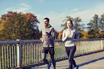 Image showing happy couple running outdoors