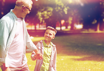 Image showing grandfather and grandson walking at summer park