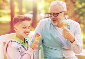 Image showing old man and boy eating ice cream at summer park