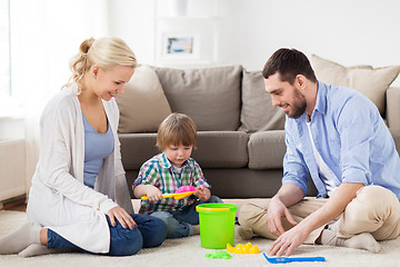 Image showing happy family playing with beach toys at home