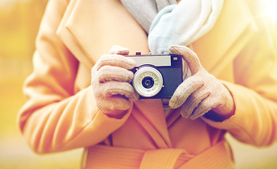 Image showing close up of woman with camera in autumn park