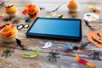 Image showing tablet pc, halloween party decorations and treats