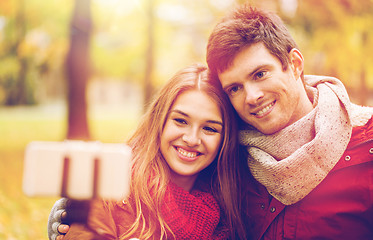 Image showing couple taking selfie by smartphone in autumn park