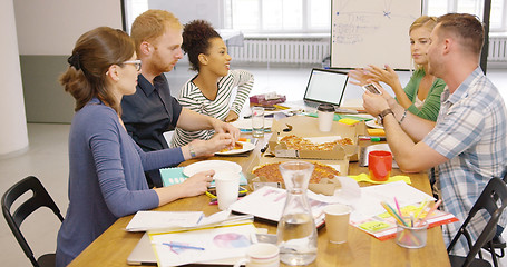 Image showing Colleagues eating pizza at office table