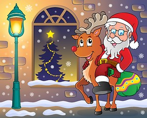 Image showing Santa Claus on reindeer in town