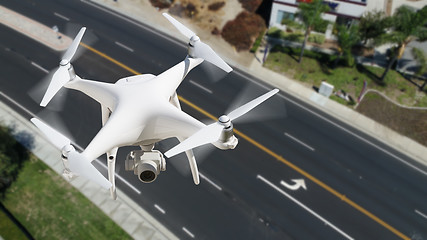 Image showing Unmanned Aircraft System (UAV) Quadcopter Drone In The Air Over 