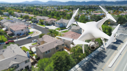 Image showing Unmanned Aircraft System (UAV) Quadcopter Drone In The Air Over 