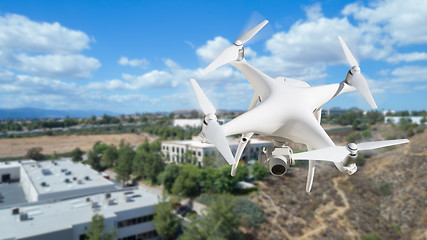 Image showing Unmanned Aircraft System (UAV) Quadcopter Drone In The Air Over 
