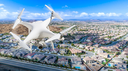 Image showing Unmanned Aircraft System (UAV) Quadcopter Drone In The Air Over 