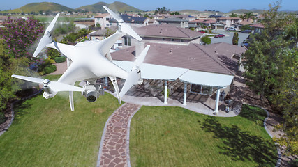 Image showing Unmanned Aircraft System (UAV) Quadcopter Drone In The Air Over 