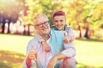 Image showing grandfather and boy showing thumbs up at summer