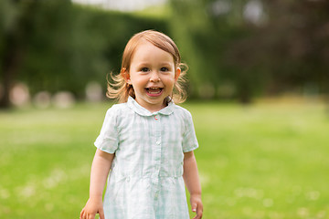 Image showing happy baby girl on green summer field