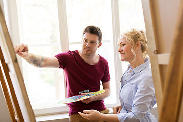 Image showing artists with palette and easel at art school