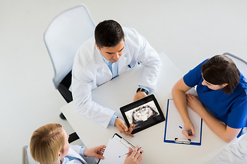 Image showing doctors with jaw x-ray on tablet pc at clinic