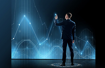 Image showing businessman in suit touching virtual graph