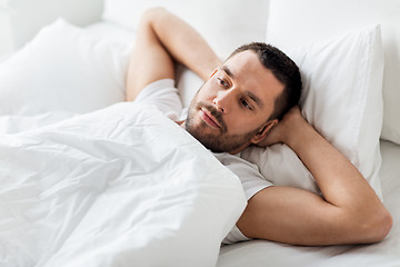 Image showing man lying in bed at home