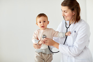 Image showing happy doctor with stethoscope and baby at clinic