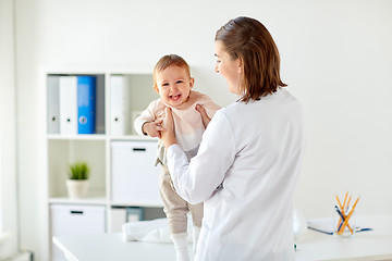 Image showing doctor or pediatrician holding baby at clinic