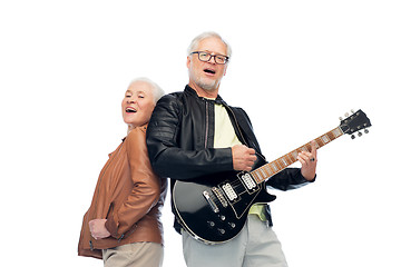 Image showing happy senior couple with electric guitar singing