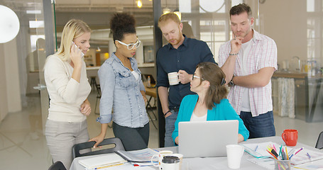 Image showing Coworkers watching laptop