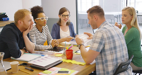 Image showing Coworkers at table with documents