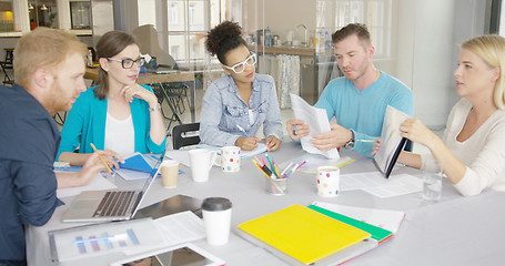 Image showing Woman showing documents to coworkers