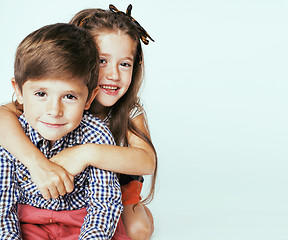 Image showing little cute boy and girl hugging playing on white background, ha