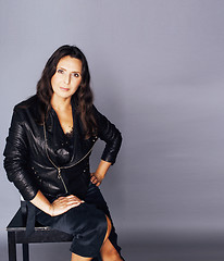 Image showing pretty brunette confident mature woman sitting on chair in studi