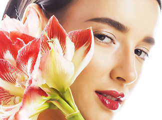 Image showing young pretty brunette woman with red flower amaryllis close up i