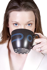 Image showing Woman Drinking Coffee Standing Up