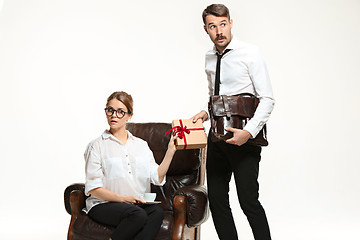 Image showing The young man and beautiful woman in business suit at office on white background