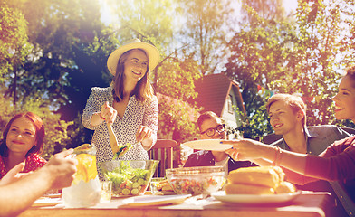 Image showing happy friends having dinner at summer garden party